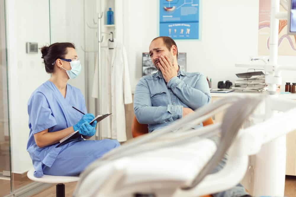 Emergency dentist in Thornton examining a patient during an urgent dental visit